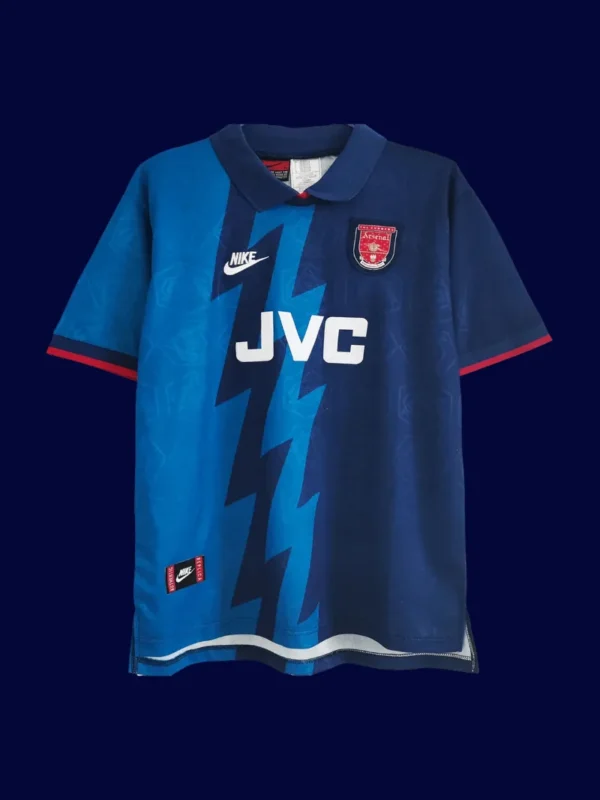 front view of blue away retro football jersey (95/96) with retro collar and stripe accents.