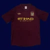 front view of Manchester City away retro jersey (12/13) in dark colors with vintage styling.