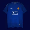 front view of Manchester United away blue retro jersey (08/09) with vintage collar and contrast trims.