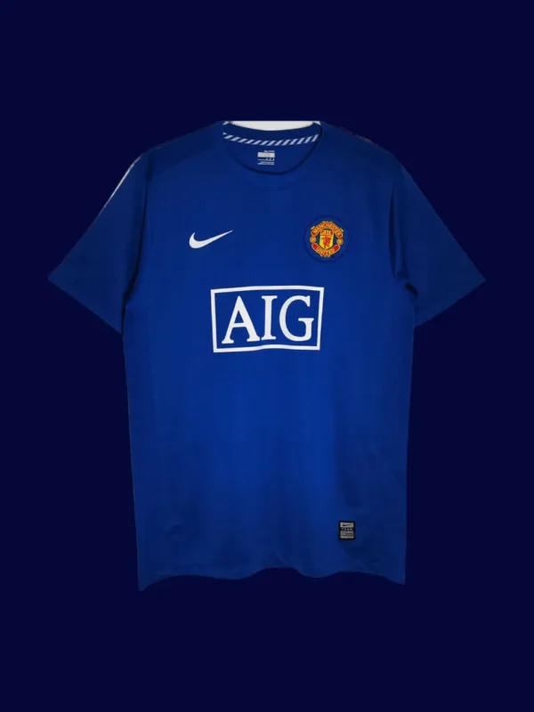 front view of Manchester United away blue retro jersey (08/09) with vintage collar and contrast trims.