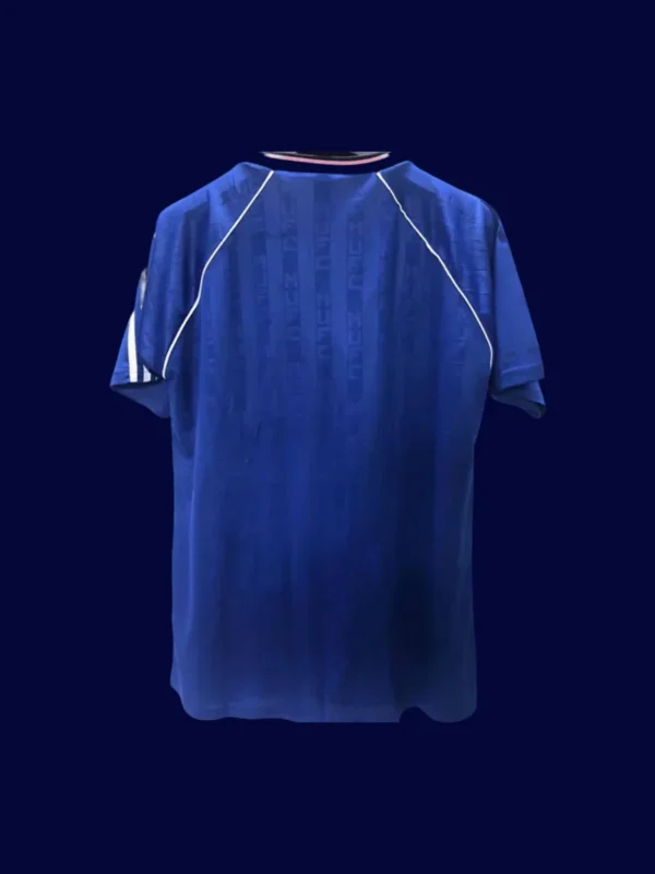 back view of away blue retro soccer jersey (88/90) showing stitched back and number area.