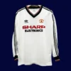 front view of Manchester United away retro long sleeve jersey (82/83) in white with classic cuffs.