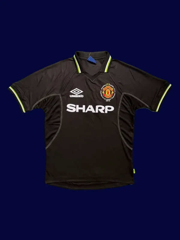 front view of Manchester United away UCL black retro jersey (98/99) with UEFA badge.
