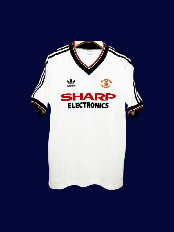 Manchester United Away White Retro Jersey 8283A - KFCool – Football Jerseys & Soccer Kits Store front view of Manchester United away white retro jersey (82/83) with vintage collar and trim.