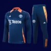 front view of blue Manchester United tracksuit (2025) with streamlined fit and zip-up jacket.