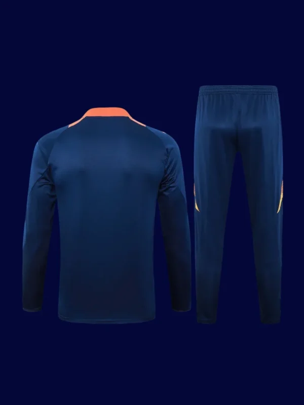 back view of blue Manchester United tracksuit (2025) showing ergonomic back and tapered hem.