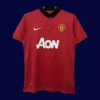 front view of Manchester United home retro jersey (13/14) with classic V-neck and red trims.