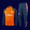 front view of orange Manchester United tracksuit (2025) with full zip and elastic cuffs.