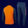 back view of orange Manchester United tracksuit (2025) showing tapered back and smooth seamwork.