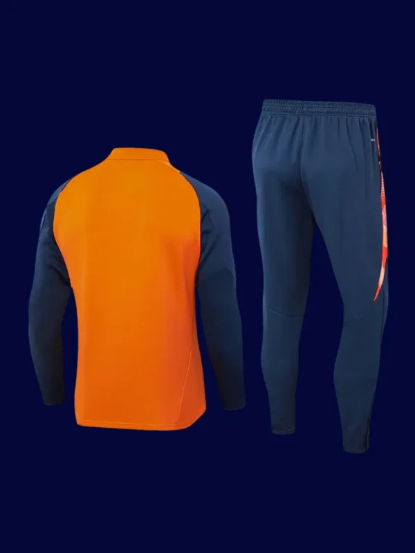 back view of orange Manchester United tracksuit (2025) showing tapered back and smooth seamwork.