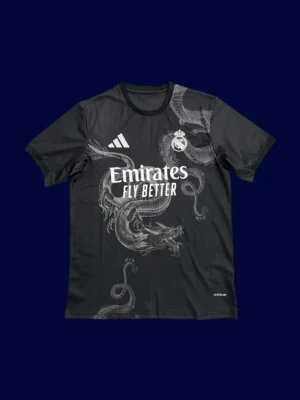 Real Madrid Black Dragon Fans Jersey 2425A front view of black dragon themed modern jersey (24/25) with detailed pattern and slim fit.