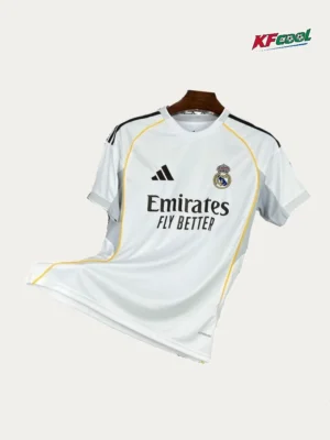 Real Madrid Home White Jersey 2526 Fans Version01 White Real Madrid jersey featuring Emirates Fly Better sponsor and Adidas logo with yellow piping on a hanger (front view).