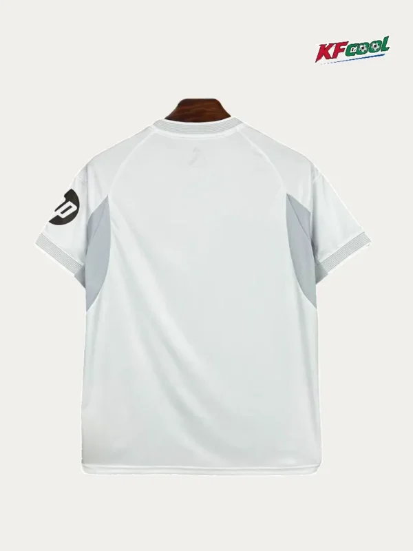 Real Madrid Home White Jersey 2526 Fans Version02 - KFCool – Football Jerseys & Soccer Kits Store Back view of a white athletic jersey with light gray side panels and ribbed sleeves; a circular logo on the left sleeve.