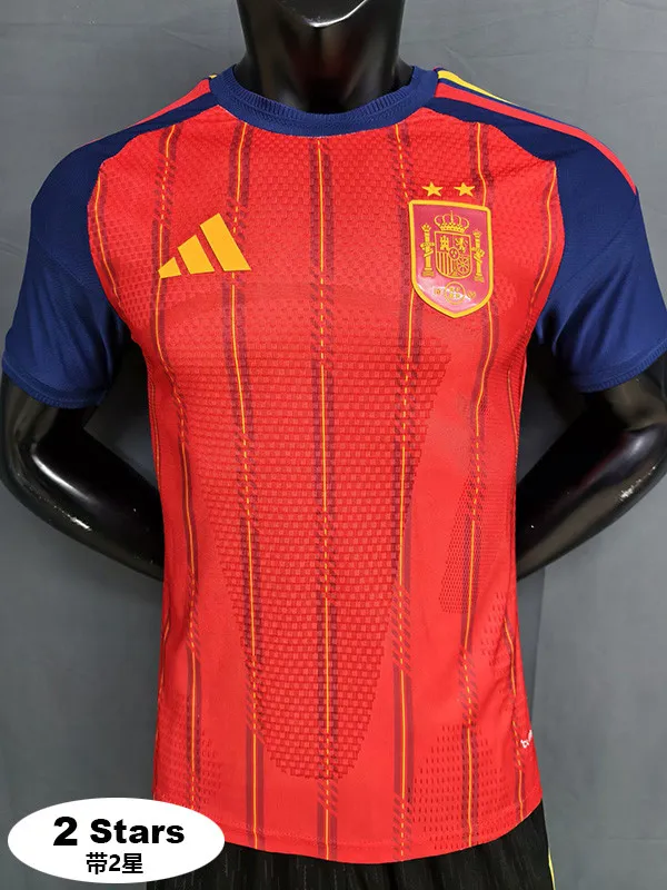 Spain national football team jersey by Adidas: red with blue sleeves, yellow Adidas logo, crest with crown and two stars on the chest.