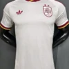 White Spain national team football jersey on a mannequin with red-yellow trim, Adidas logo left chest, Spain crest with two stars on the right chest, 2 Stars badge visible in bottom-left corner