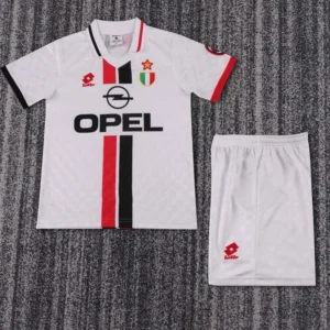 White soccer jersey with red and black vertical stripe, Opel sponsor, Italian crest, and matching white shorts.