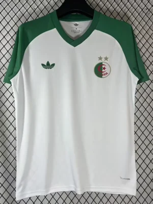 White soccer jersey with green sleeves on a hanger; left chest has Adidas logo, right chest shows circular Algeria crest with two stars.