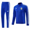 Blue Adidas tracksuit jacket with white stripes and crest, paired with matching blue track pants with stripes on the sides. Informal athletic wear set (jacket + pants).
