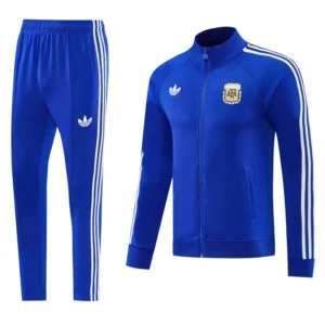 Blue Adidas tracksuit jacket with white stripes and crest, paired with matching blue track pants with stripes on the sides. Informal athletic wear set (jacket + pants).