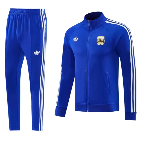Blue Adidas tracksuit jacket with white stripes and crest, paired with matching blue track pants with stripes on the sides. Informal athletic wear set (jacket + pants).