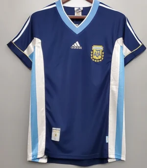 Argentina 1998/99 Retro Away Jersey Fan Version - Front View Blue Argentina national football jersey with light blue trim, hanging on a hanger; features Adidas logo and crest on chest.