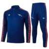 Arsenal 2025/26 Royal Blue Half Pull Tracksuit - Front View - KFCool – Football Jerseys & Soccer Kits Store Blue athletic tracksuit with red and white stripes along sleeves and legs, featuring small chest and thigh logos.