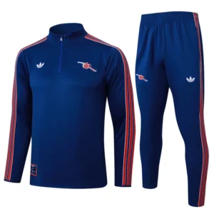 Blue athletic tracksuit with red and white stripes along sleeves and legs, featuring small chest and thigh logos.