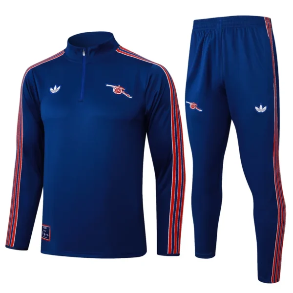 Arsenal 2025/26 Royal Blue Half Pull Tracksuit - Front View - KFCool – Football Jerseys & Soccer Kits Store Blue athletic tracksuit with red and white stripes along sleeves and legs, featuring small chest and thigh logos.