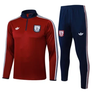 Arsenal 2025/26 Red White Half Pull Tracksuit - Front View Arsenal training suit: red long-sleeve top with navy collar and white stripes, paired with navy pants featuring Arsenal crest.