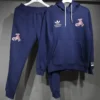 Navy blue tracksuit on hangers: hoodie with white drawstrings and front pocket, joggers with a red A logo on the leg and brand logos on chest.
