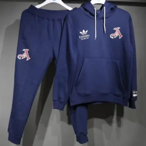 Navy blue tracksuit on hangers: hoodie with white drawstrings and front pocket, joggers with a red A logo on the leg and brand logos on chest.