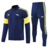 Arsenal 2026/27 Royal Blue Jacket Tracksuit - Front View - KFCool – Football Jerseys & Soccer Kits Store Navy blue tracksuit with yellow accents: zip-up jacket with yellow shoulder stripes and arm bands, matching pants with side stripes and logos.