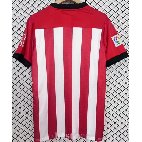 Athletic Bilbao 2011/12 Retro Home Jersey Fan Version - Back View Red soccer jersey with white vertical stripes hanging on a hanger, black cuffs on the sleeves, against a grid backdrop.