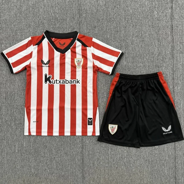 Athletic Bilbao 2026/27 Home Kids Kit Fan Version - Front View - KFCool – Football Jerseys & Soccer Kits Store Red-and-white striped soccer jersey with black collar and Kutxabank sponsor, crest on left chest, paired with black shorts with red side panels.