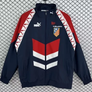 Atlético Madrid 1995/96 Retro Black Red Windbreaker - Front View Navy blue Puma track jacket with red sleeves, white chevron accents, and Atlético Madrid crest on the chest; front zipper and elastic hem.