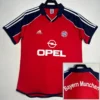 Bayern Munich 2000/01 Retro Home Jersey Fan Version - Front View Red Bayern Munich football jersey with blue sleeves featuring white stripes; displays Adidas logo, Opel sponsor, and Bayern crest on the chest.