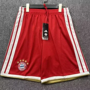 Bayern Munich 2026/27 Home Shorts - Front View Red Bayern Munich athletic shorts with white side stripes and gold hem, Adidas tag attached on hanger