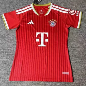 Bayern Munich 2026/27 Home Women Jersey Fan Version - Front View Red FC Bayern Munich football jersey with white Adidas logo, T‑Mobile sponsor, and club crest with five gold stars, laid flat on a grey surface.
