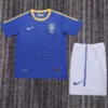 Brazil 2010/11 Retro Away Kids Kit Fan Version - Front View - KFCool – Football Jerseys & Soccer Kits Store Blue Brazil football jersey with yellow trim and dotted design, paired with white shorts featuring a blue Nike swoosh.