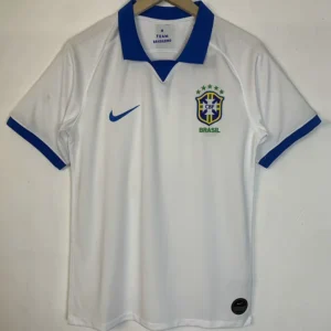 Brazil 2019/20 Away Jersey Fan Version - Front View White Brazil national team polo jersey with blue collar, Nike swoosh, and CBF crest, hanging on a wooden hanger.