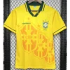 Brazil 1993/94 Retro Home Jersey Fan Version - Front View Yellow Brazil national football team jersey on a hanger, with green collar trim and CBF crest on the chest, and large shield graphics across front.