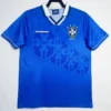 Blue Brazil national team soccer jersey with CBF crest and Umbro logo, hanging on a hanger in front of a white background.
