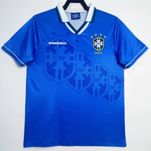 Blue Brazil national team soccer jersey with CBF crest and Umbro logo, hanging on a hanger in front of a white background.