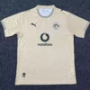 Beige Borussia Dortmund away jersey laid flat, showing BVB 09 crest, Vodafone sponsor, and the Puma logo on the chest.