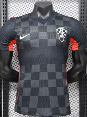 Dark gray and black checkered soccer jersey on a mannequin, featuring a white Nike swoosh and HNS crest with red side panels.