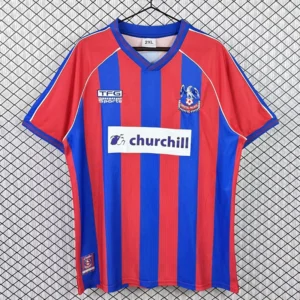 Crystal Palace 1999/00 Retro Home Jersey Fan Version - Front View Red and blue striped soccer jersey on a hanger with Churchill sponsor logo in the center and team crest on the chest.