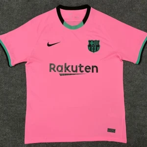 Bright pink FC Barcelona football jersey with black Nike swoosh, club crest, and Rakuten sponsor across the chest.