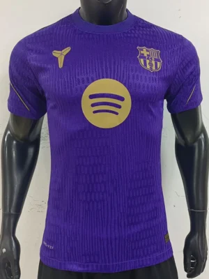 Front view of a purple FC Barcelona jersey on a mannequin, featuring a gold Spotify logo across the chest and the club crest on the left.