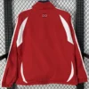 Back view of a red athletic jacket with white side panels and sleeve accents; small circular logo near the collar on the upper back.
