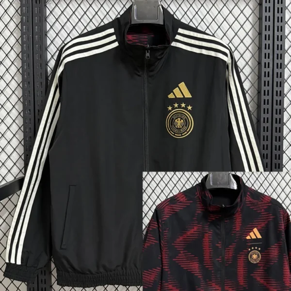 Black Adidas track jacket with white three-stripe sleeves and gold German national team crest on the left chest; zip front, elastic hem.